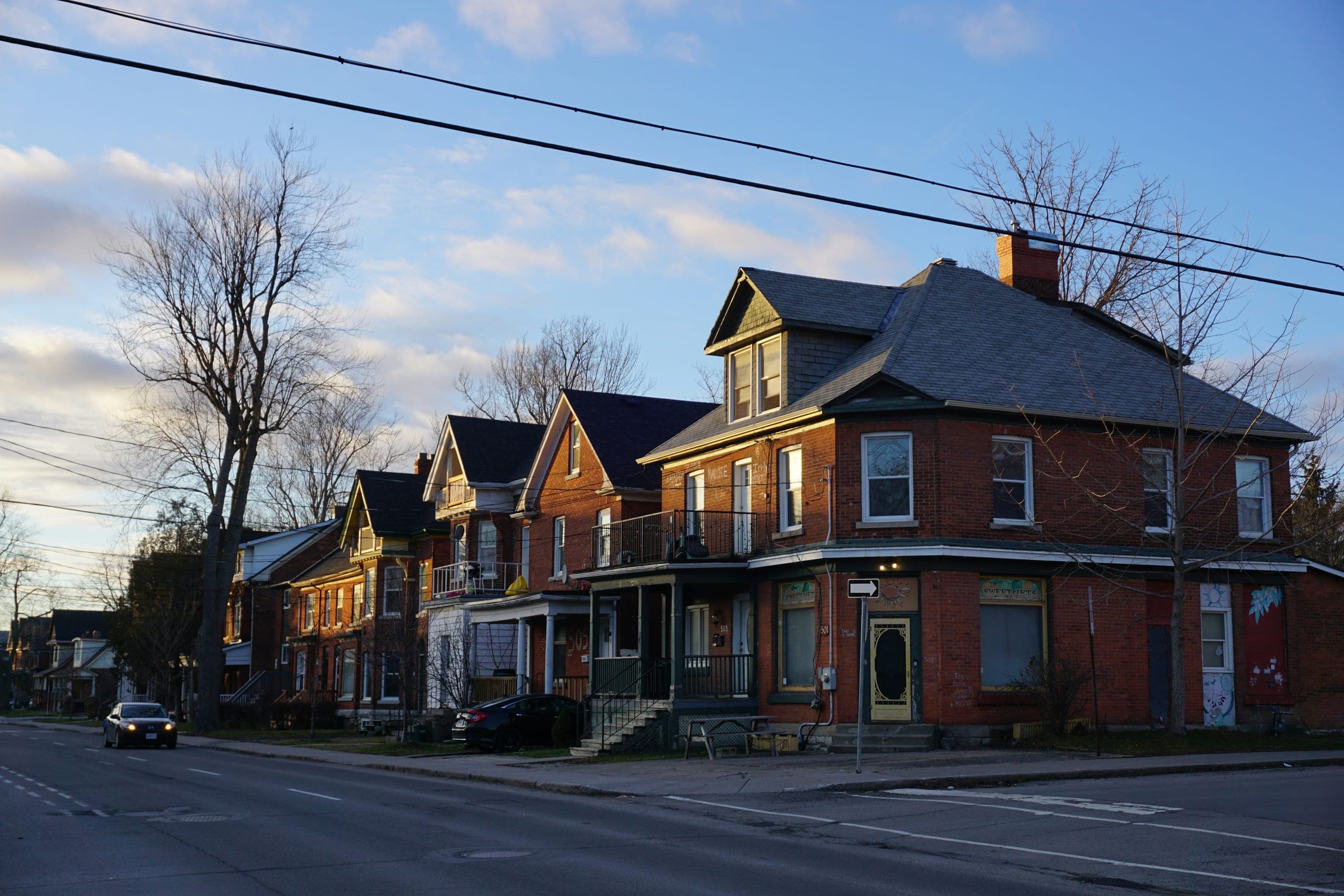 Brick houses on a Kingston side street near campus at dusk