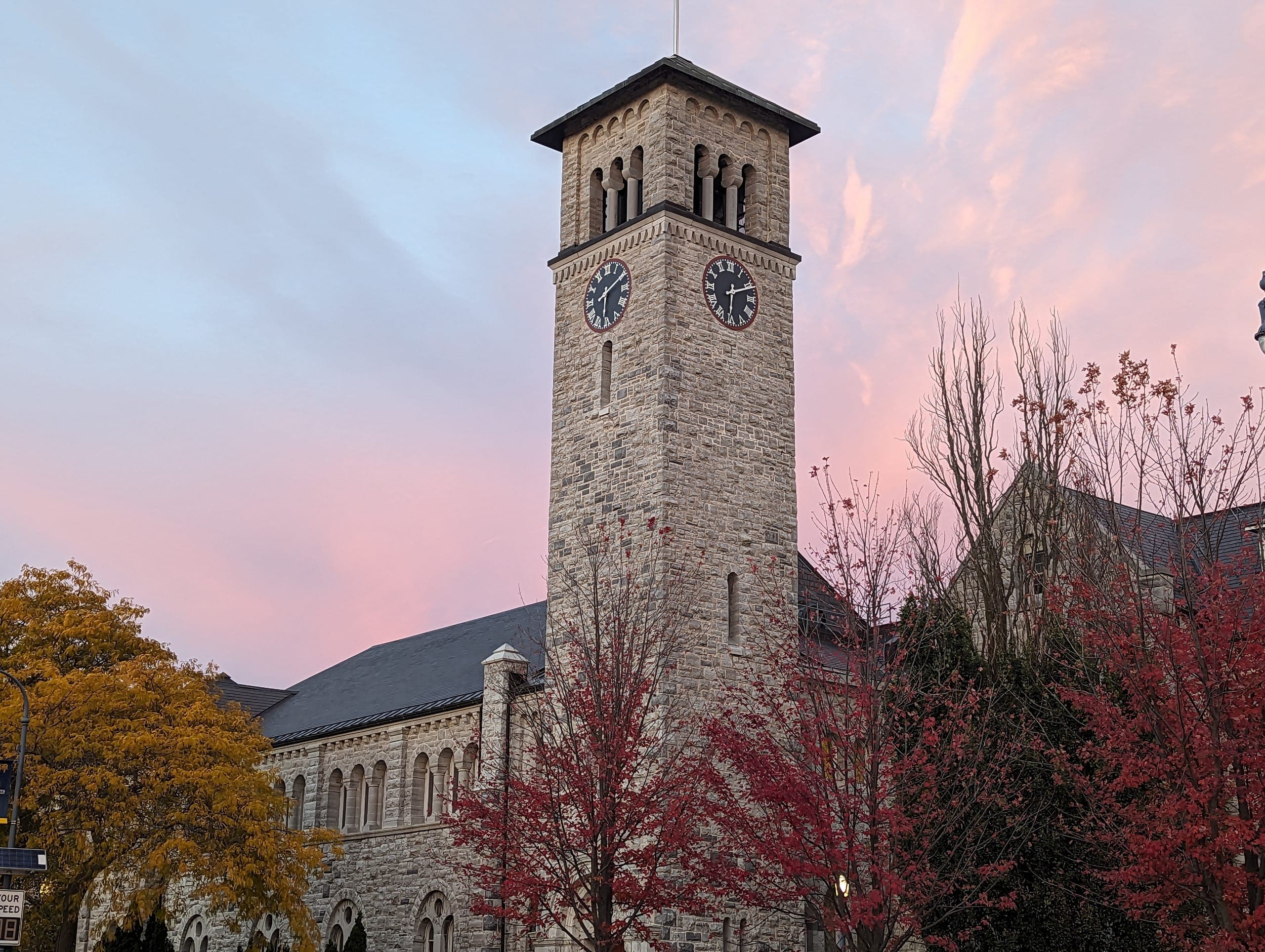 Grant Hall and its clock tower at Queen's University on an autumn afternoon
